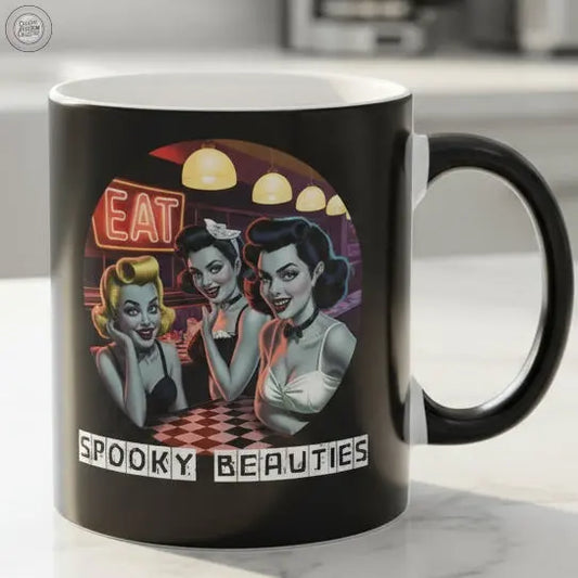 Black mug with vintage-style design featuring women and text 'Eat Spooky Beauties' on a white background.
