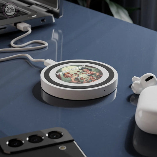 Wireless charging pad with phone, laptop, and earbuds on a dark surface